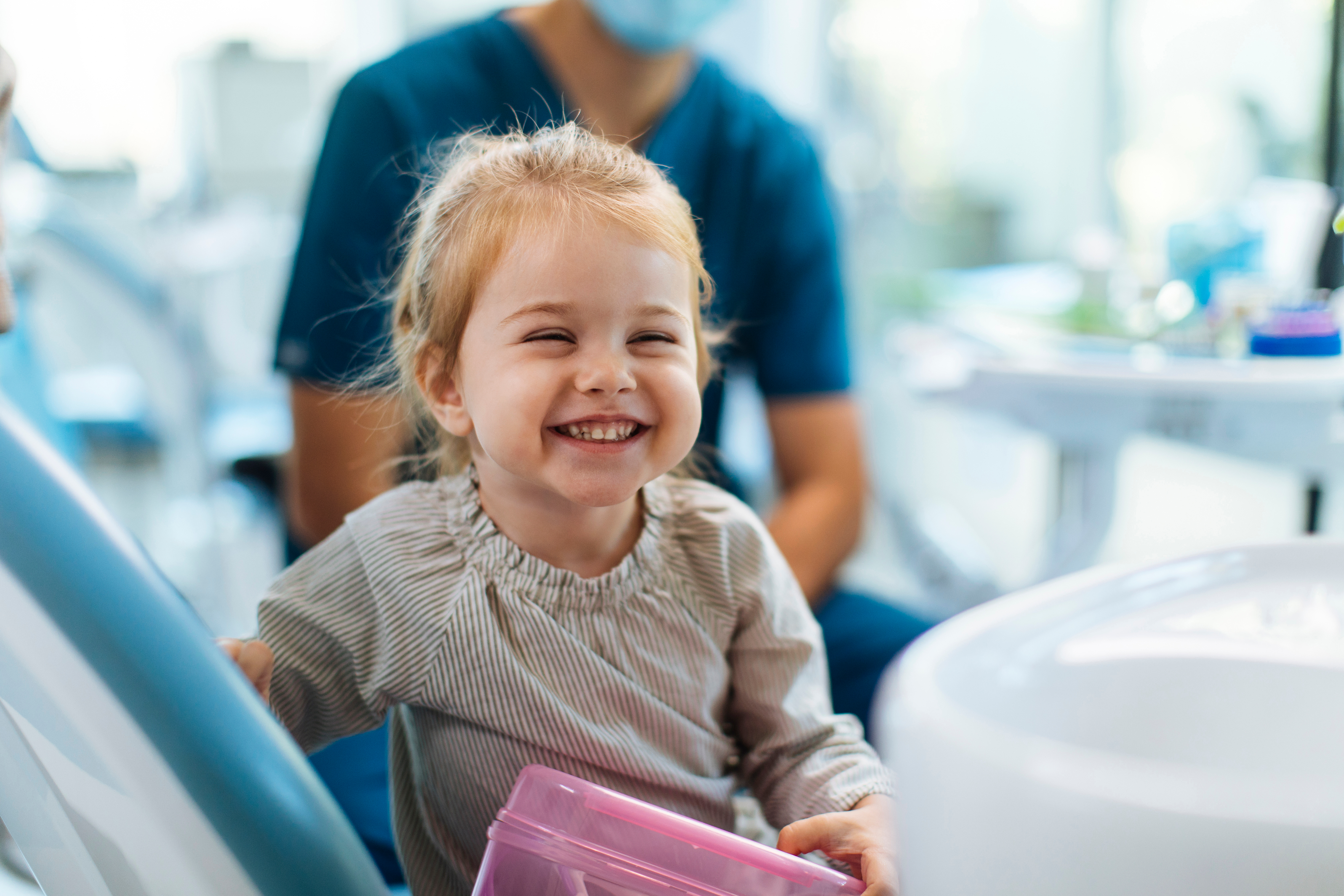 Happy child patient smiling in dental chair